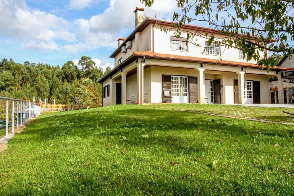 a house with a large yard in front of it at Martins House in Arouca