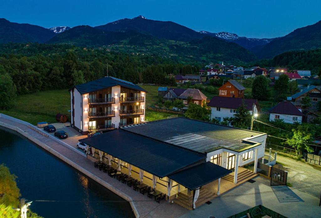 an aerial view of a building next to the water at Complex Pescăresc Gura Repezii Borșa in Borşa