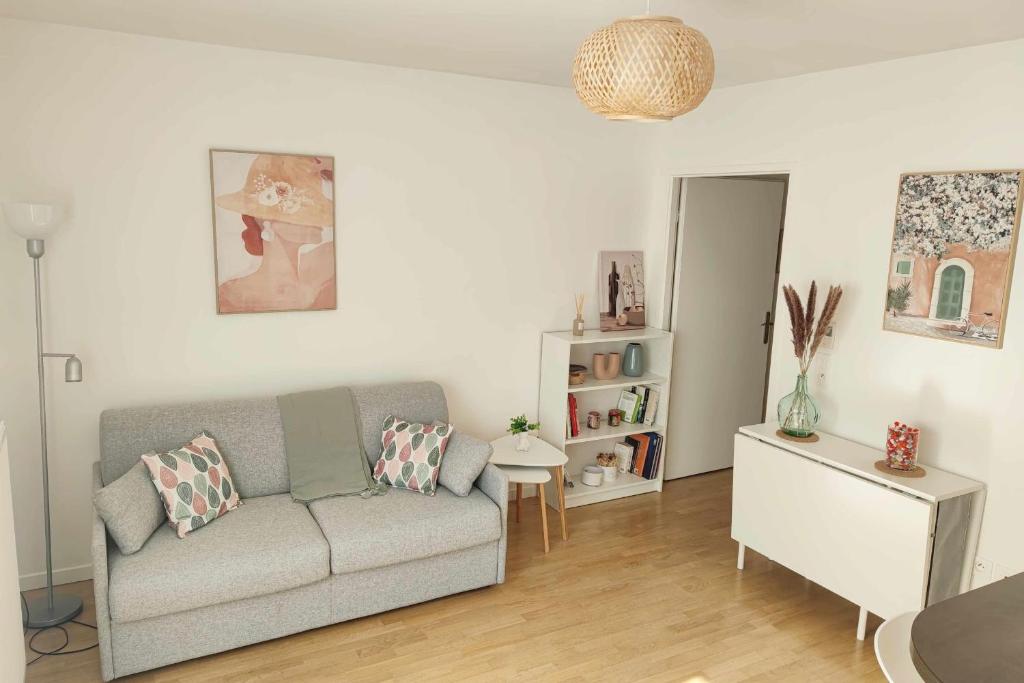 a living room with a couch and a table at Bright and fully renovated studio in Vanves in Vanves