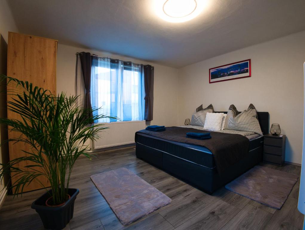 a bedroom with a large bed and a potted plant at Ferienhaus Pottschach 