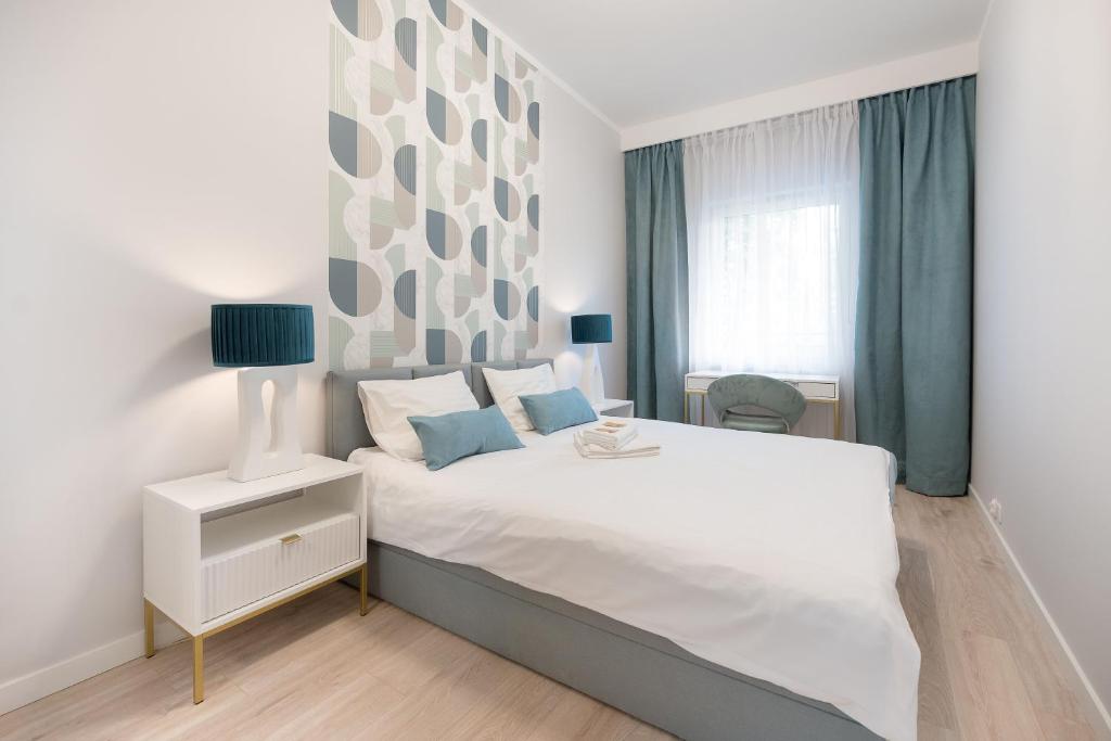 a bedroom with a large white bed and a window at HomeStay 3 with private parking in Toruń