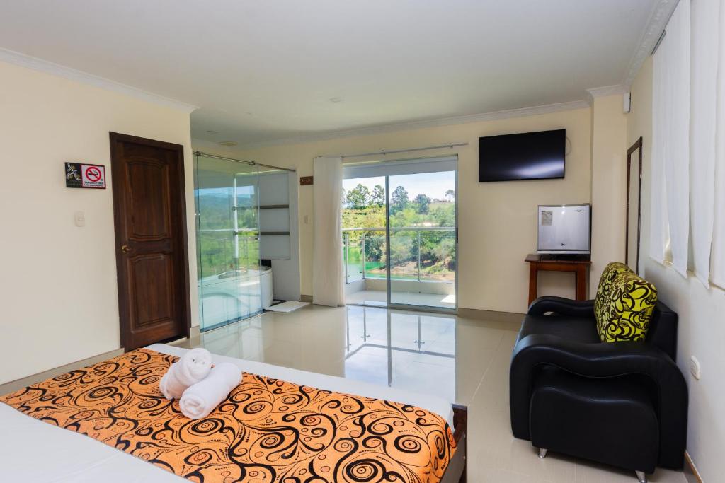 Postel nebo postele na pokoji v ubytování Hotel Verony Guatape