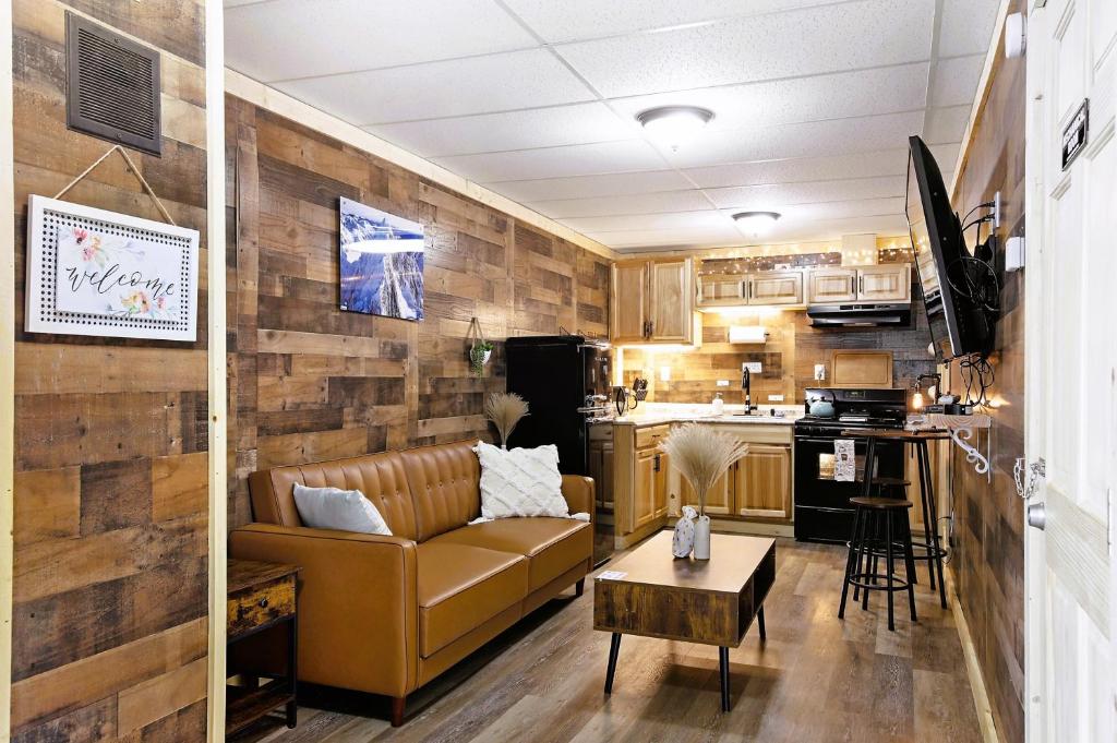 a living room with a couch and a kitchen at Leadville Motor Lodge in Leadville