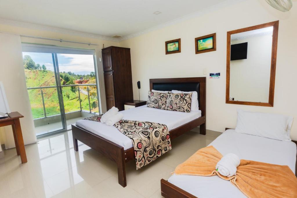 Postel nebo postele na pokoji v ubytování Hotel Verony Guatape