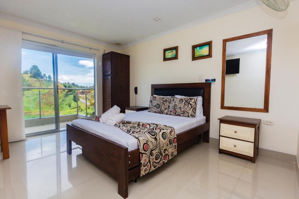 Postel nebo postele na pokoji v ubytování Hotel Verony Guatape