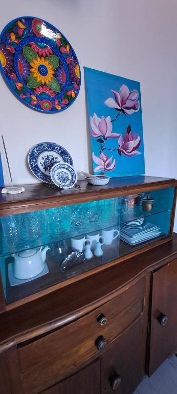 a wooden cabinet with plates and dishes on it at Ayres de Catamarca in San Fernando del Valle de Catamarca