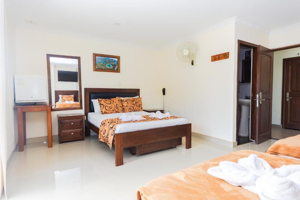 Postel nebo postele na pokoji v ubytování Hotel Verony Guatape