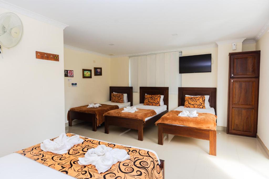 Postel nebo postele na pokoji v ubytování Hotel Verony Guatape