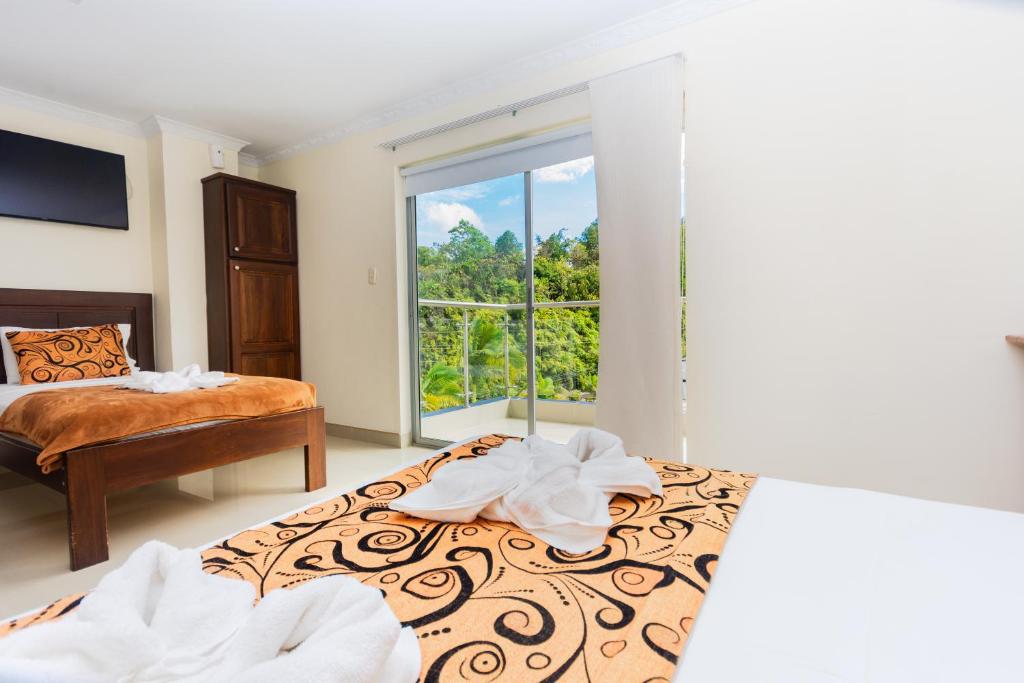 Postel nebo postele na pokoji v ubytování Hotel Verony Guatape