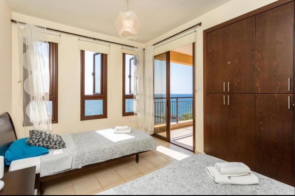 a bedroom with a bed and a view of the ocean at Mermaid Villa in Pomos