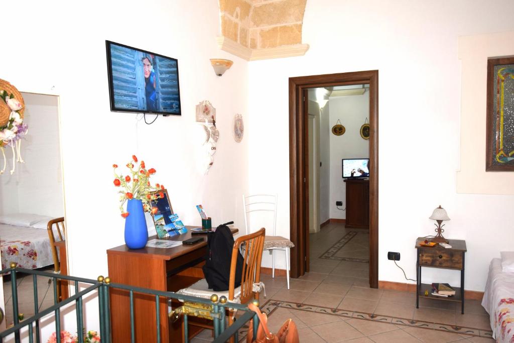 Televízia a/alebo spoločenská miestnosť v ubytovaní Casa Naida