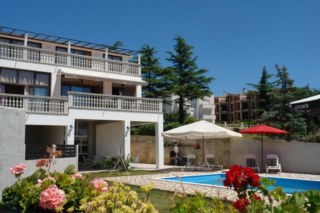 une villa avec une piscine et un bâtiment dans l'établissement Apartments Nada, à Medulin
