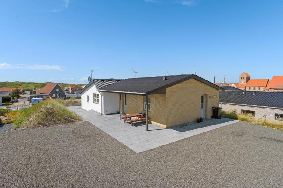 a home with a patio and a house at Bakkebo in Hvide Sande
