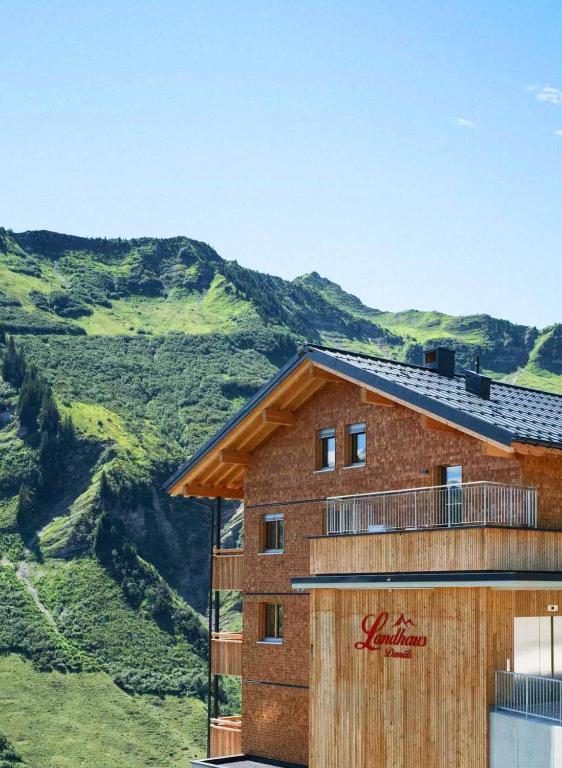 a building with a mountain in the background at Landhaus Damüls in Damuls