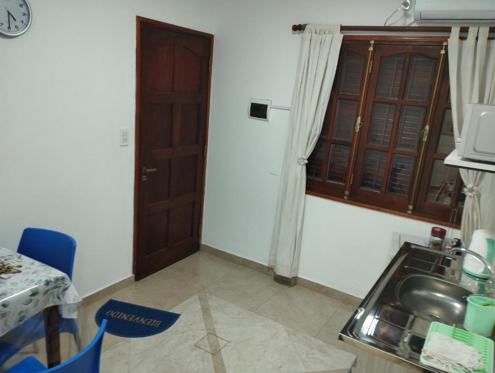 a kitchen with a sink and a table and a door at Albajunin in Junín