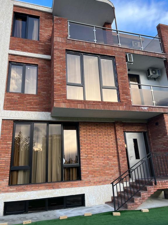 a red brick building with windows and a staircase at villa with beautiful views in Tbilisi City