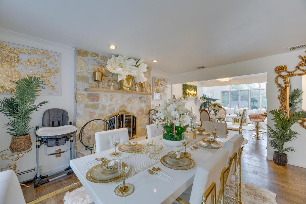 a dining room with a white table and a fireplace at Dreams of Paradise Luxury Home with Pool! 