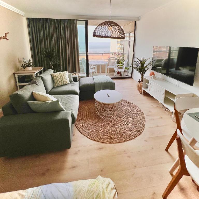 a living room with a couch and a tv at Studio Sea View - Royal Ascot in Ostend