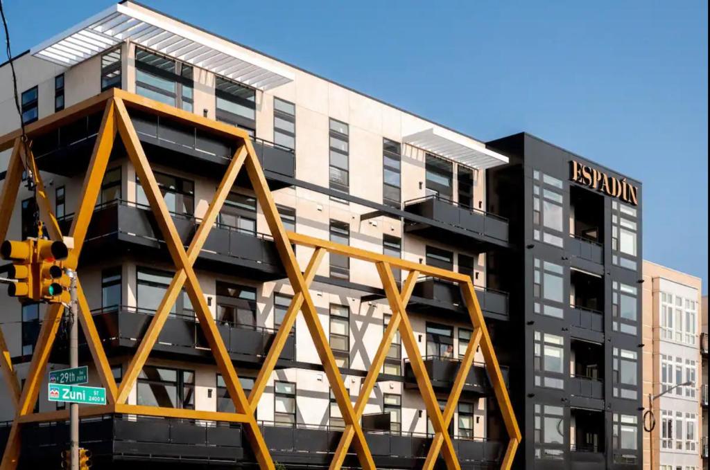 an apartment building with a metal structure in front of it at Relaxed Elegance | Espadin LoHi in Denver