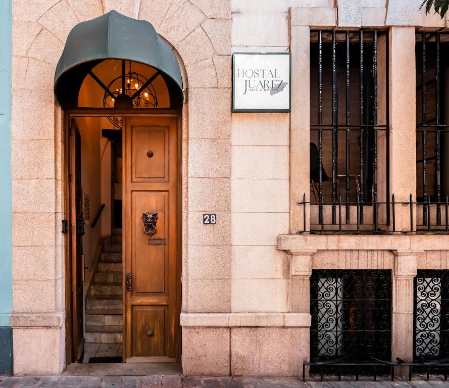 a door to a building with a sign on it at Hostal Juarez in Mexico City