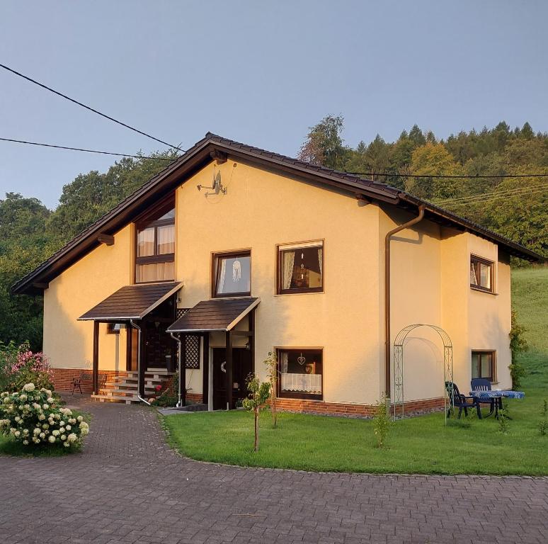 una casa grande con césped delante en Ferienwohnung Kirschblüte 