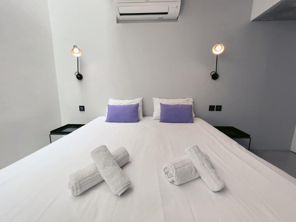 a large white bed with three pillows on it at STUNNING AND SPACIOUS - 1BR PENTHOUSE in Valletta