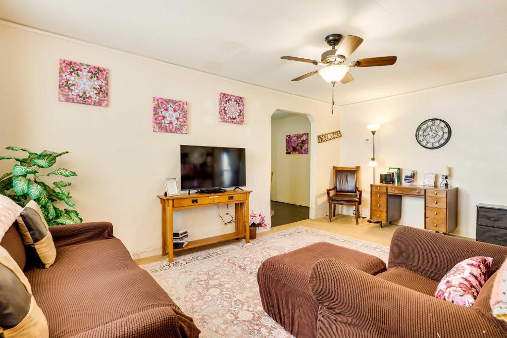 a living room with a couch and a flat screen tv at Cottage with Furnished Deck 1 Mi to Dtwn Craig! in Craig