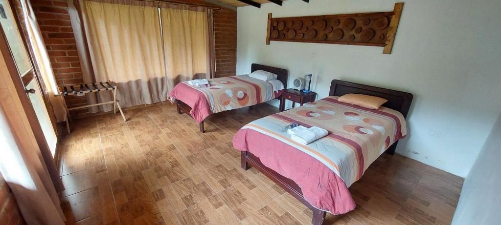 Postel nebo postele na pokoji v ubytování Mindo Loma bird lodge