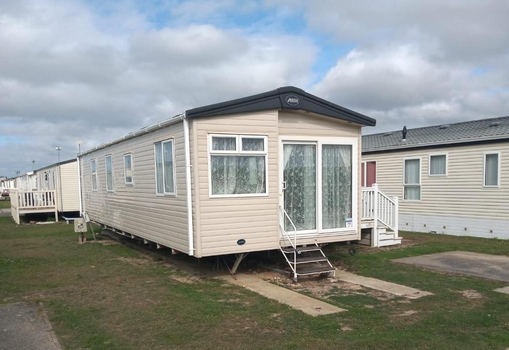 a tiny house is parked in a yard at Your Retreat Too in Camber