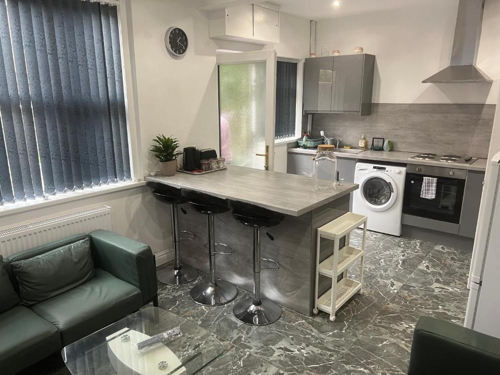 a kitchen with a counter in the middle of a room at Tarleton house in Stoke on Trent