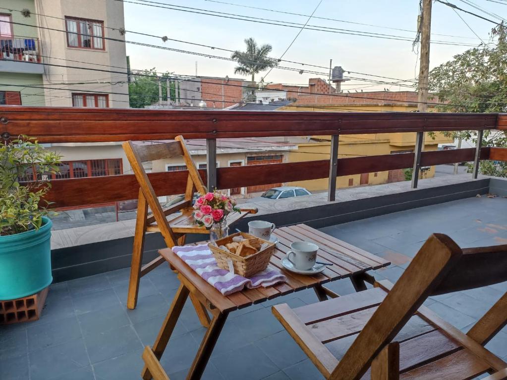 a balcony with a table and chairs on a roof at Los Jazmines in San Salvador de Jujuy