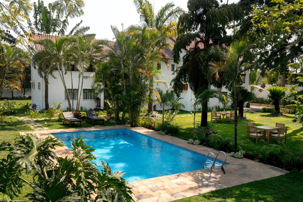 a swimming pool in the yard of a house at Brubru Lodge in Moshi