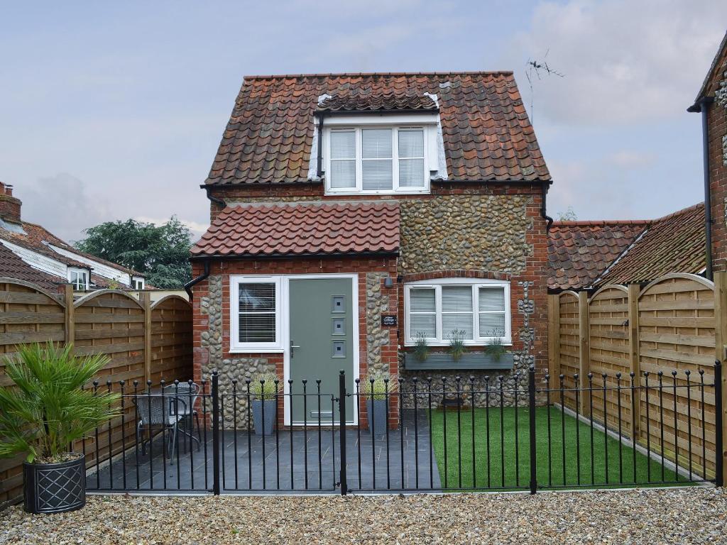 a house with a fence in front of it at Willow Cottage in Great Ryburgh