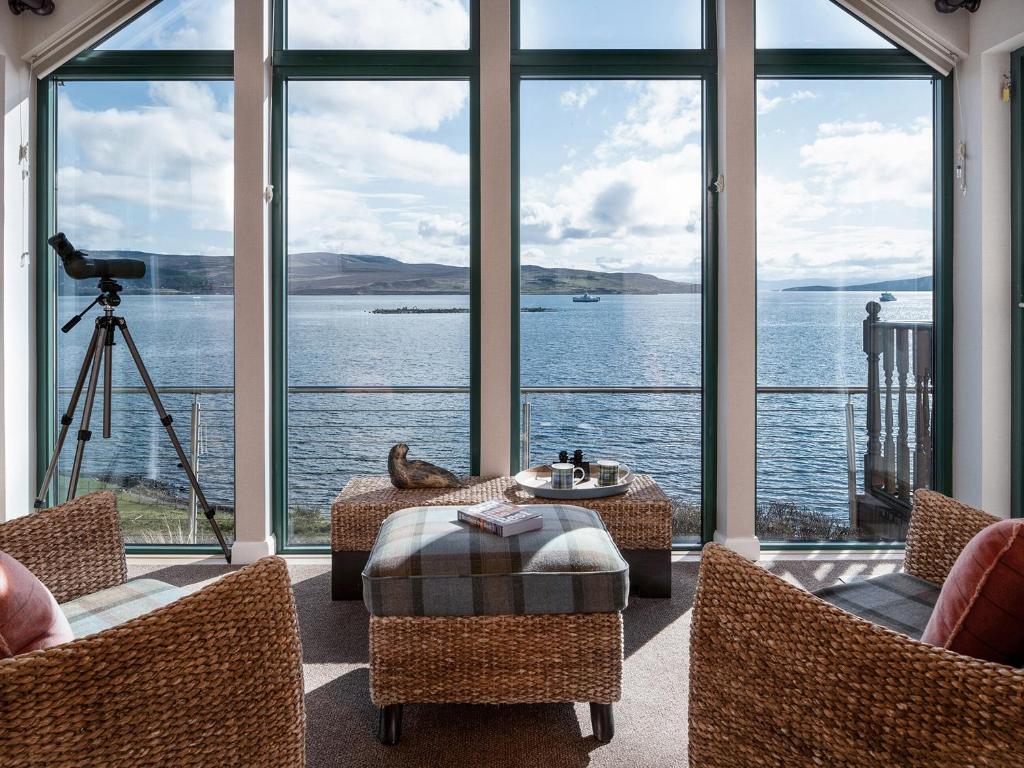 a living room with a view of the water at Kyles View in Ollach