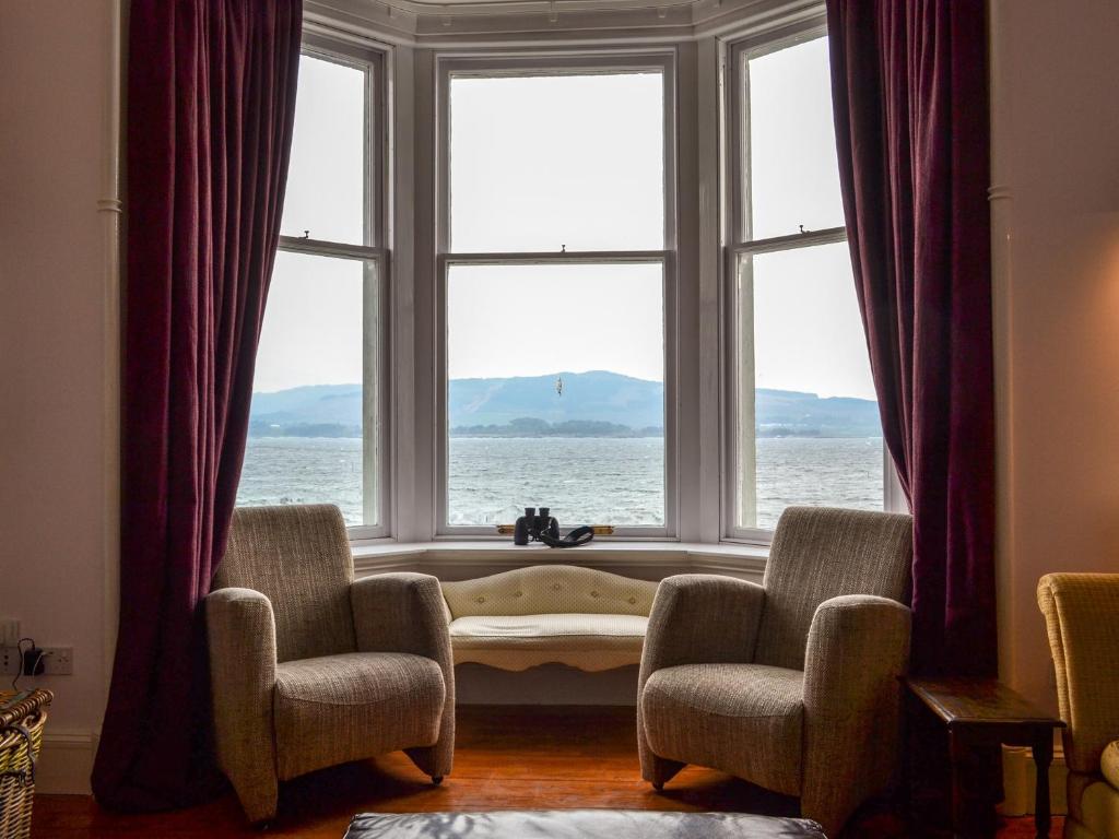 a window with a view of the ocean in a room at Fircliff - The House On Bute in Port Bannatyne