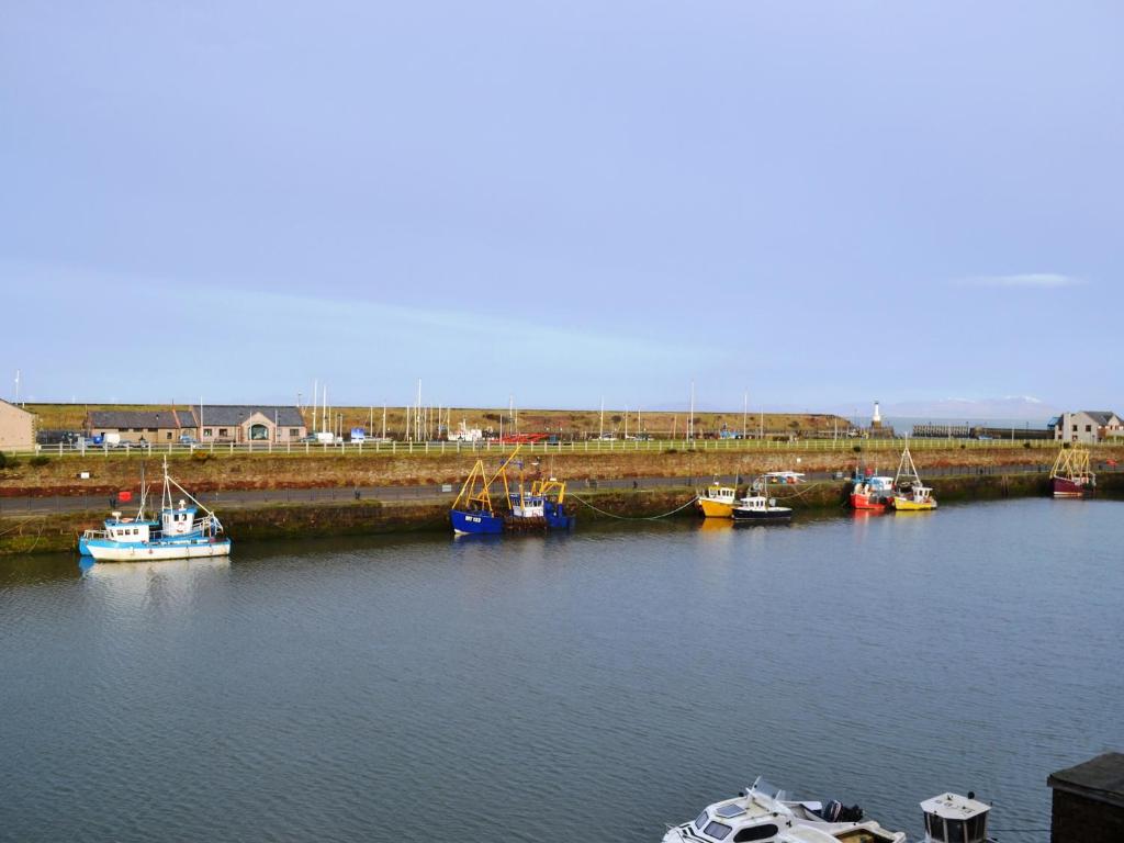 a group of boats are docked in a harbor at Ritson Wharf in Maryport
