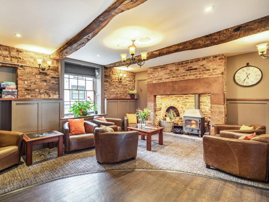 a living room with couches and a fireplace at The Scotch Arms Mews - Uk30910 in Brampton