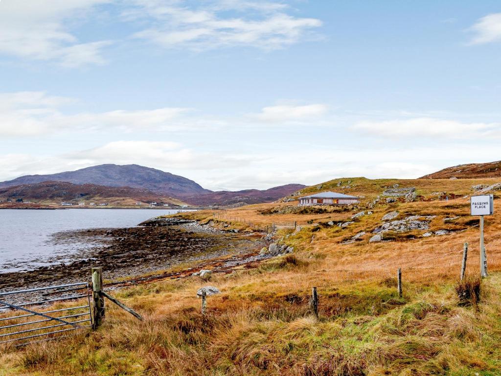 a house on a hill next to a body of water at Riof Bay - Uk31251 in Valtos