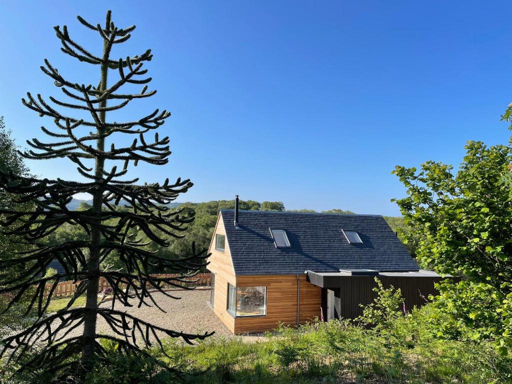 a wooden house with solar panels on the roof at Barrach in Ardfern