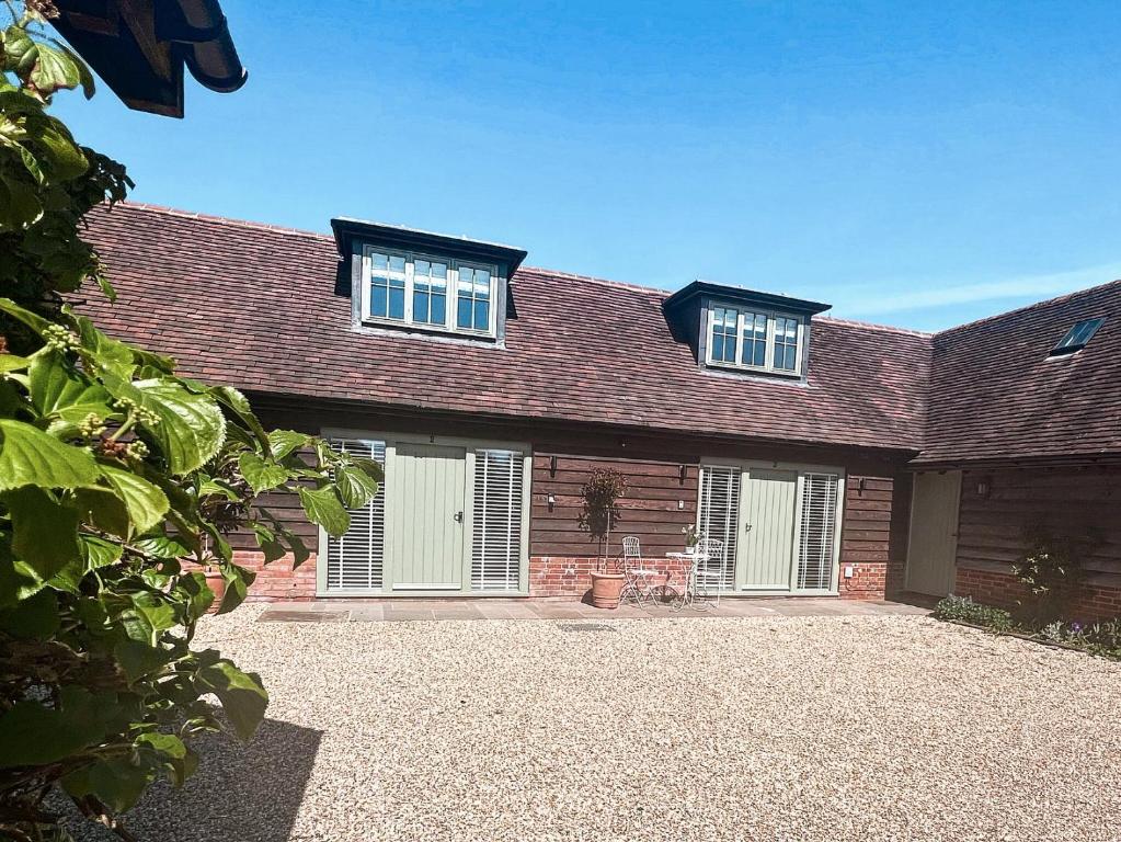 a brick house with two windows and a driveway at The Old Stables 3 - Uk35690 in West Winterslow