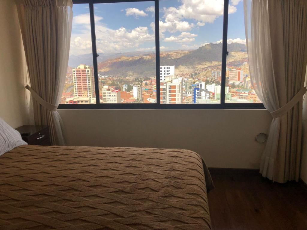 - une chambre dotée d'une fenêtre offrant une vue sur la ville dans l'établissement Familiar y acogedor, à La Paz