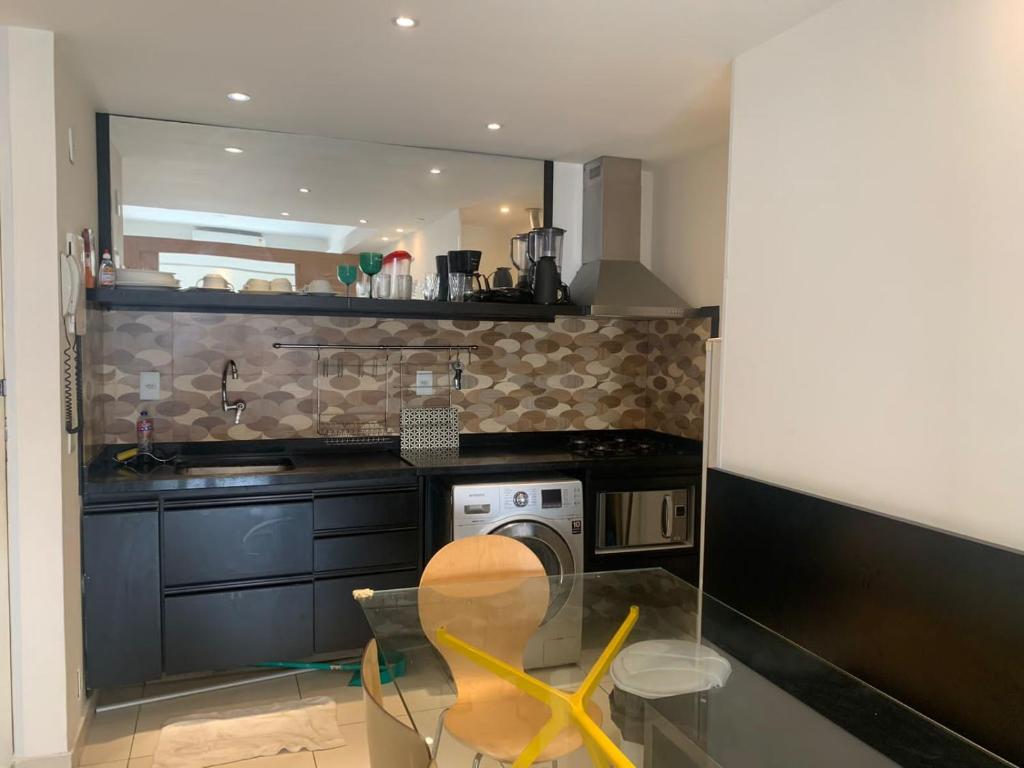 a kitchen with a glass table and a sink at Real Apartments 255 - High level Copacabana 2 bedrooms close to Ipanema in Rio de Janeiro