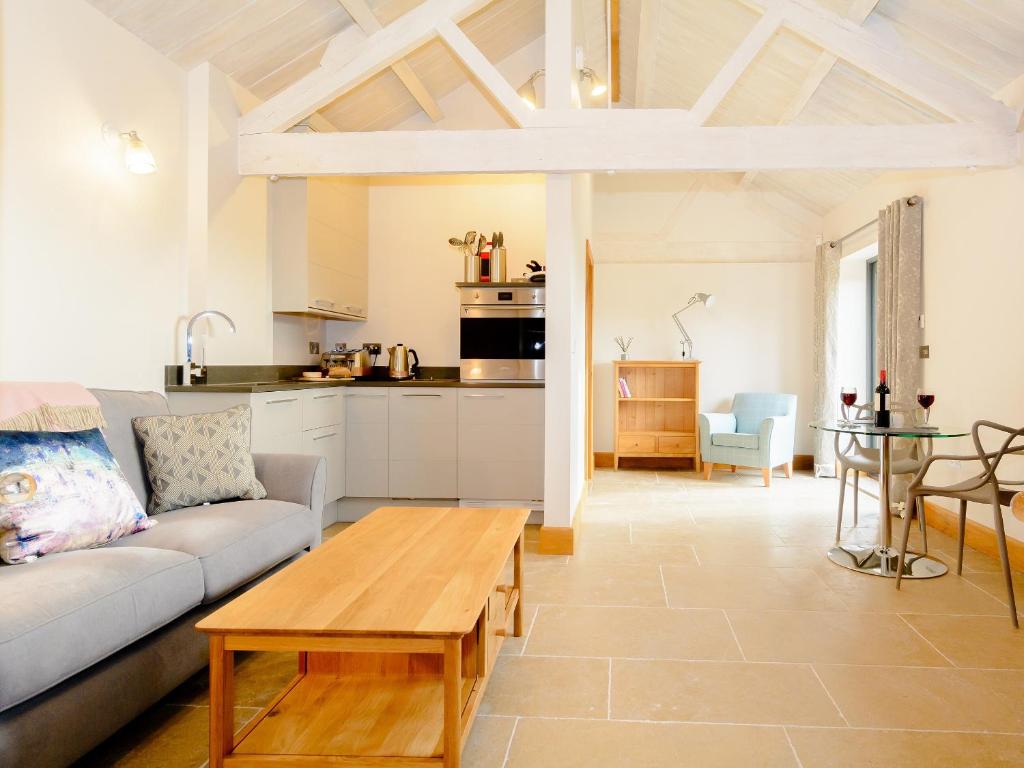 a living room with a couch and a table at Bluebell Barn - Uk12792 in Royal Wootton Bassett