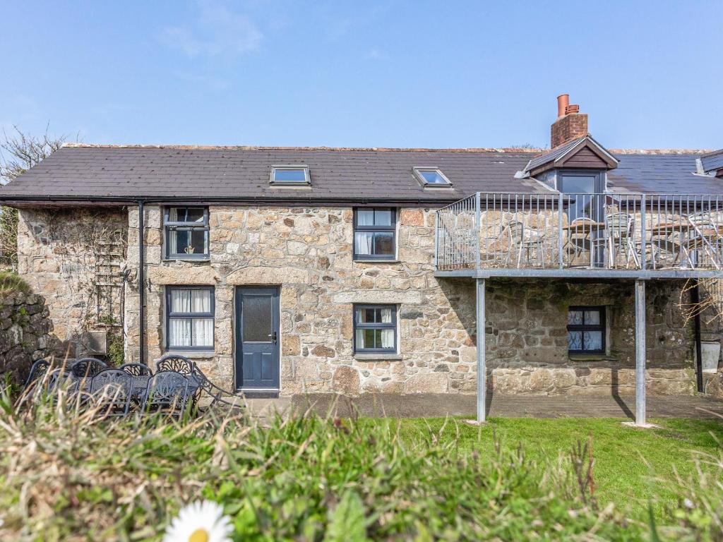 a stone house with a balcony on the front of it at The Cottage - Uk10514 in Carbis Bay