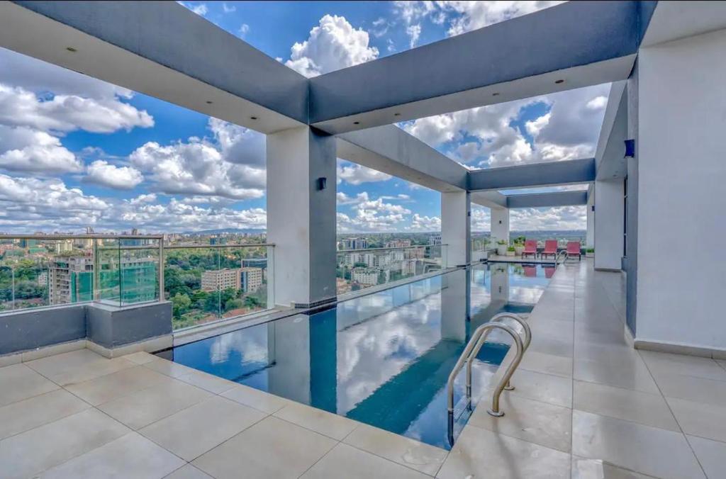 an indoor swimming pool with a view of the city at Lantana Cosy Home Studio Apartment in Nairobi
