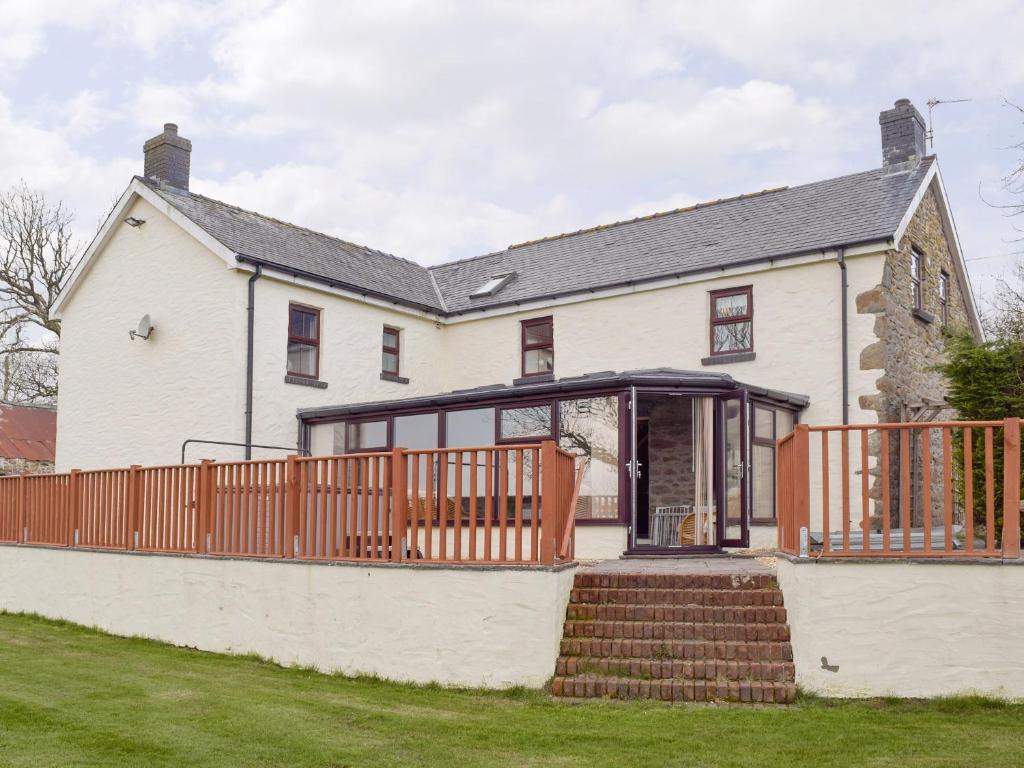 an external view of a white house with a deck at Brynhowell in Llanglydwen