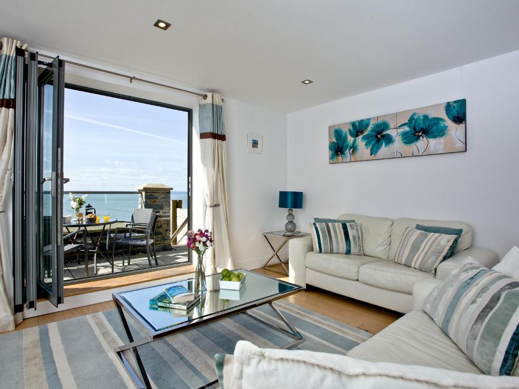 a living room with a couch and a table at 4 Ocean Point in Croyde