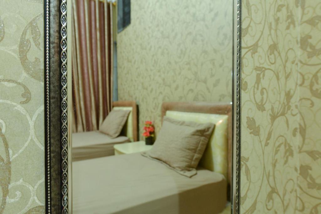 Postel nebo postele na pokoji v ubytování Hotel Alifa Syariah
