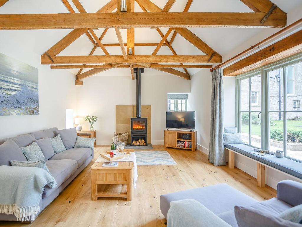 a living room with a couch and a fireplace at The Stable - Uk35021 in Long Houghton