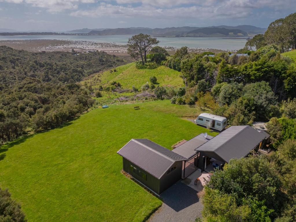 an aerial view of an rv and a field of grass at Whangapoua Hideaway - Whangapoua Bach in Whangapoua